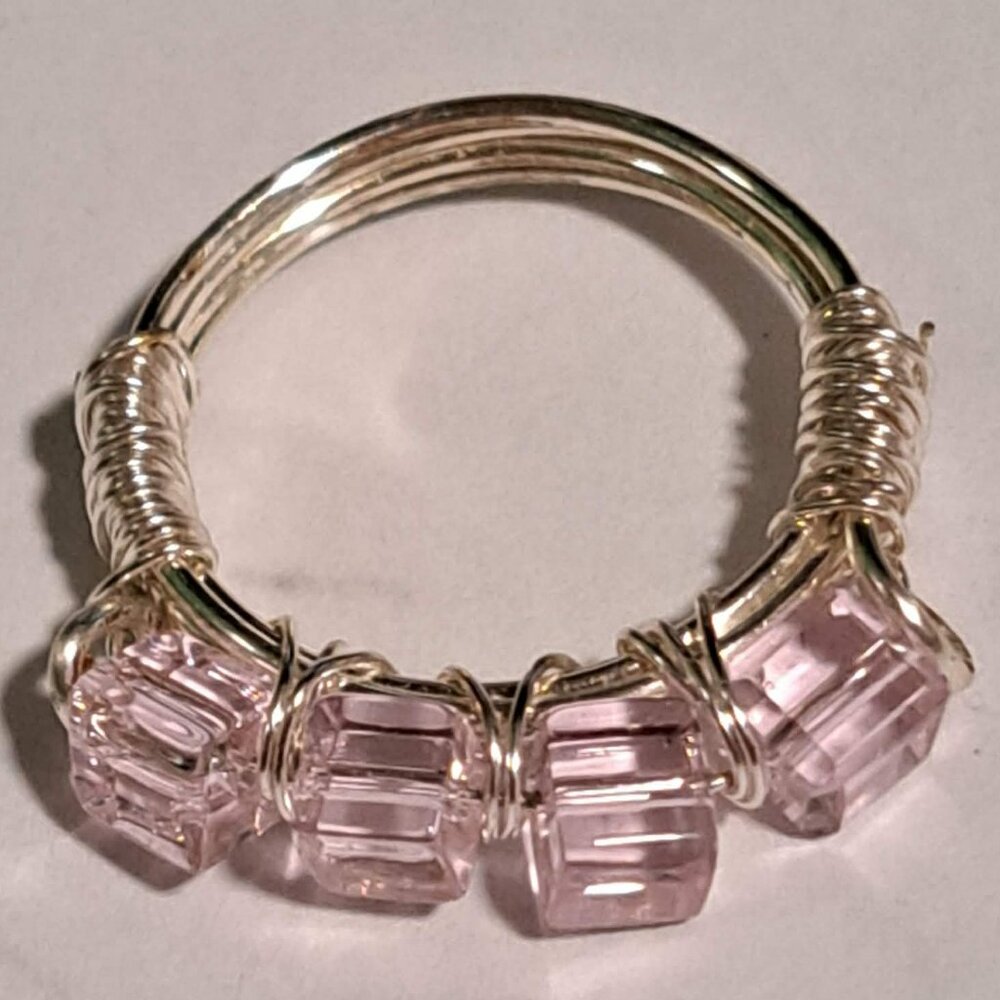 Pink beads on a silver color wire ring
